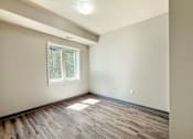 Thumbnail 15 of 20 - A room with wooden flooring and a window.