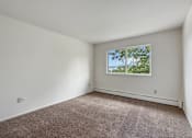 Thumbnail 8 of 10 - A room with a window showing trees outside.