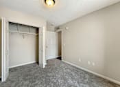 Thumbnail 7 of 15 - A room with a grey carpet and a white door.