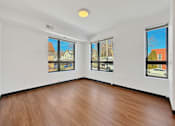 Thumbnail 7 of 46 - Another angle of a Stryker Senior Apartments in West St. Paul room with wooden floor and white walls, and big windows.
