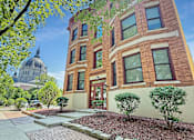 Thumbnail 2 of 15 - A building with a brick facade and a dome in the background.