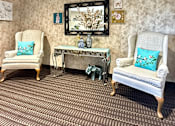 Thumbnail 4 of 16 - A room with two chairs and a bench.