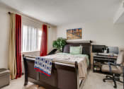 Thumbnail 20 of 30 - bedroom with red and gold curtains , large bed and small office area with computer and chair