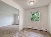 Thumbnail 7 of 10 - A room with a window and a tiled floor.