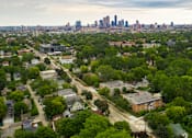 Thumbnail 10 of 12 - Ariel view of Homestead with Minneapolis skyline in the background