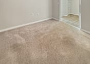 Thumbnail 21 of 31 - A room with a carpeted floor and a white door.