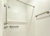 Thumbnail 21 of 21 - A white shower stall with a glass door and a silver handle.