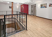 Thumbnail 22 of 34 - A staircase with a black railing and wooden steps.