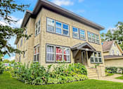 Thumbnail 27 of 27 - A house with a green lawn in front.
