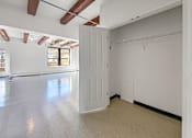 Thumbnail 31 of 34 - A large empty room with white walls and a window.