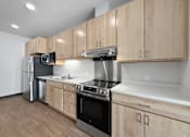 Thumbnail 43 of 43 - A kitchen with wooden cabinets and stainless steel appliances.