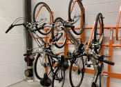 Thumbnail 30 of 37 - a row of bikes hanging on a rack in a garage