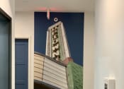 Thumbnail 28 of 37 - a mural of a building on the wall of a hallway