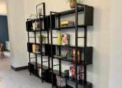 Thumbnail 26 of 37 - a bookshelf in the corner of a room with a wood floor