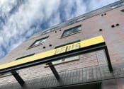 Thumbnail 25 of 37 - the facade of a building with a sign on it