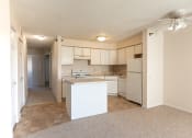 Thumbnail 8 of 30 - view of kitchen from living room, view of living room carpet, and kitchen vinyl flooring