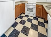 Thumbnail 17 of 34 - A kitchen with black and white checkered floor.