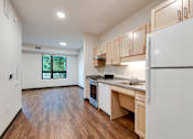Thumbnail 35 of 46 - another view of a Stryker Senior Apartments in West St. Paul kitchen with wood flooring and white appliances