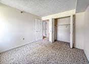Thumbnail 10 of 40 - A room with a carpeted floor and white walls.