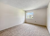 Thumbnail 9 of 40 - A room with a carpeted floor and a window.