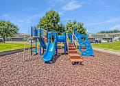 Thumbnail 15 of 40 - A playground with a blue slide and a brown slide.