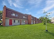 Thumbnail 9 of 29 - A photo of a green lawn and blue skies over Liberty Plaza Townhome and Apartments