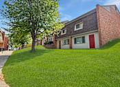 Thumbnail 1 of 29 - A tree in front of Liberty Plaza Townhome building