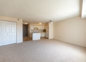 Thumbnail 4 of 30 - living room carpet with view of kitchen