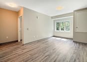 Thumbnail 14 of 20 - A room with wooden flooring and a window.