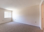 Thumbnail 15 of 30 - Vacant bedroom with window and carpet