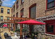Thumbnail 4 of 30 - A patio and red umbrella at 653 Artists Lofts