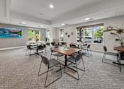 Thumbnail 5 of 19 - A room with a long table surrounded by chairs.