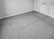 Thumbnail 7 of 19 - A room with a ceiling fan and a carpeted floor.