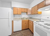 Thumbnail 12 of 27 - A kitchen with white appliances and wooden cabinets.