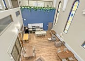 Thumbnail 9 of 27 - A church interior with wooden floors and white furniture.