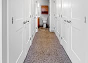 Thumbnail 20 of 27 - A Closet at Stonehouse Square in Northeast Minneapolis leading to a bathroom