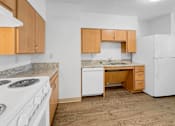 Thumbnail 19 of 27 - A kitchen at Stonehouse Square Apartments with white appliances