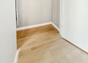 Thumbnail 5 of 22 - A white closet with a white door and a white shelf.