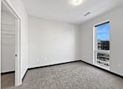 Thumbnail 26 of 43 - A room with white walls and a carpeted floor.