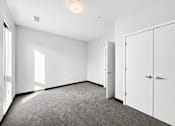 Thumbnail 36 of 43 - A room with a carpeted floor and white walls.