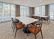 Thumbnail 5 of 43 - A conference room with a large table and chairs.