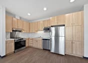 Thumbnail 7 of 43 - A kitchen with wooden cabinets and stainless steel appliances.