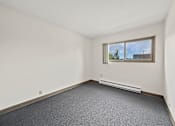 Thumbnail 20 of 29 - A photo of a Liberty Plaza Townhome bedroom with window and carpeted floor