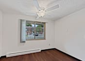 Thumbnail 24 of 29 - A photo of a dining area at Liberty Plaza Townhomes with luxury vinyl plank, a ceiling fan and a window.