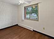 Thumbnail 15 of 29 - A photo of a dining area at Liberty Plaza Townhomes with luxury vinyl plank, a ceiling fan and a window.