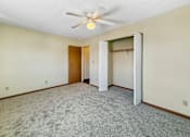Thumbnail 5 of 12 - A room with a ceiling fan and a carpeted floor.