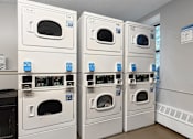 Thumbnail 34 of 35 - A laundry room with stacked dryers