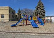 Thumbnail 35 of 35 - A playground with a blue slide and a yellow structure.