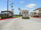 Thumbnail 31 of 40 - the entrance to a house with a driveway and a gated entrance with two gates