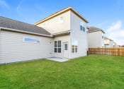Thumbnail 21 of 22 - a backyard with green grass and a white house with a gray roof